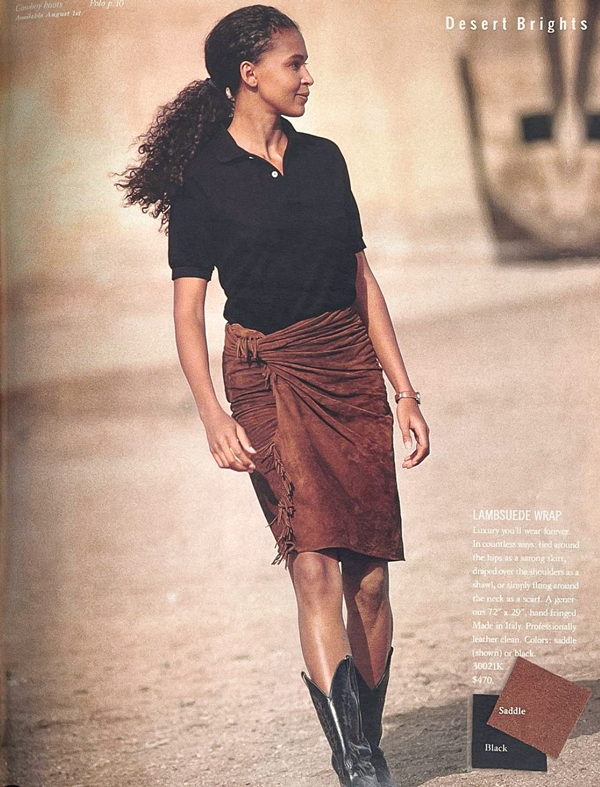 lady wearing black button up t shirt, beige skirt on the beach