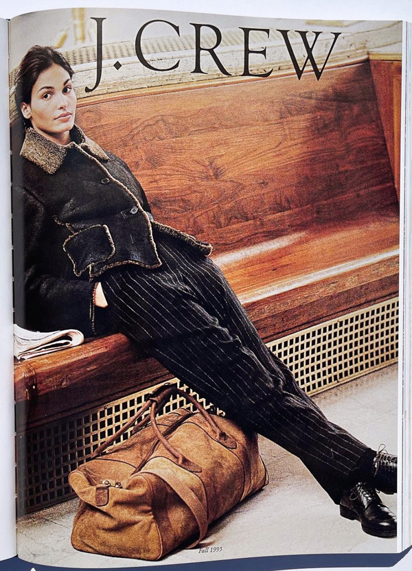 lady sitting on a bench with black jacket, black trousers, duffle bag