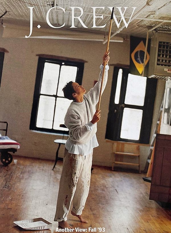 woman painting ceiling in baggy white jeans and sweater